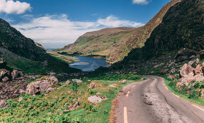 The scenic road of Gap of Dunloe, a narrow mountain pass in county Kerry, Ireland, with Augher lake...