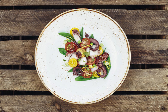 Octopus salad with seasonal tomatoes and green peas