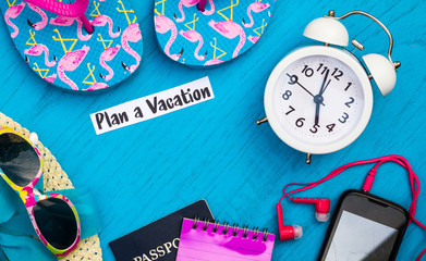 Plan a Vacation still life concept in bright colors and blue board, flat lay in vintage tones