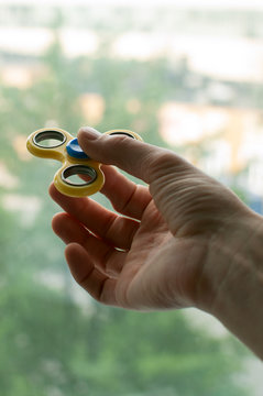 Holding a fidget spinner