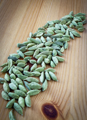 Cardamom Pods on Wooden Board