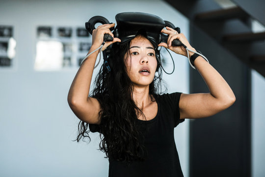 South-East asian girl playing VR game