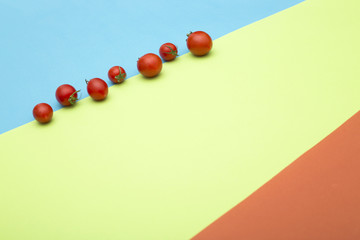 Abstract still life with tomatoes on a colored background