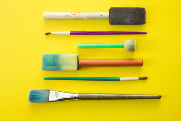 Fototapeta premium Children's Paint Brushes on a Yellow Background