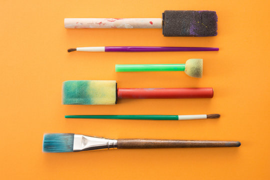 Children's Paint Brushes on a Orange Background