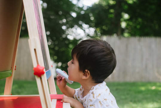 Little Kid At His Chalkboard