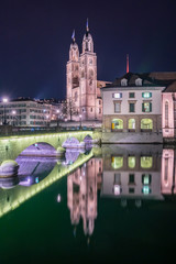 View of Grossmunster and Zurich old town from Limmat river. The Grossmunster is a Romanesque-style Protestant church in Zurich, Switzerland