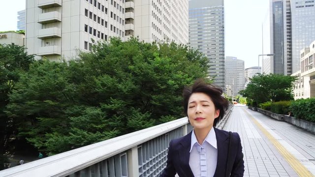 ビジネスウーマン・時計を見て全速力で走る