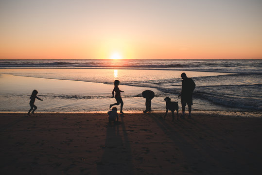 Family in motion on the beach