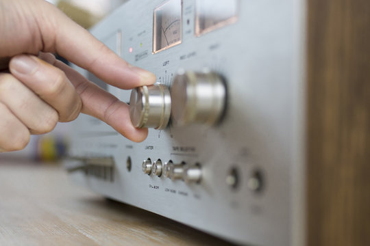 Hand Cranking a Dial on a Vintage Home Stereo Equipment
