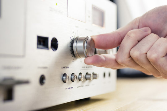 Hand Turning a Knob on a Vintage Hi-Fi Equipment