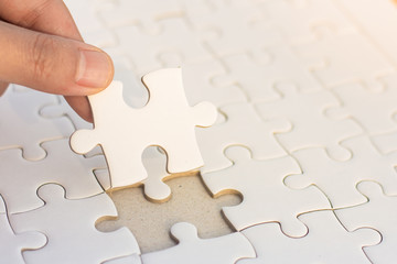 Hands put puzzle pieces last jigsaw puzzle, business concept for completing the final puzzle...