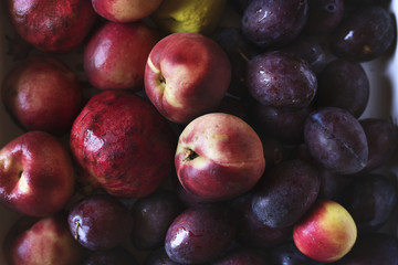Closeup of plums and other fruits