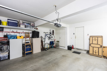 Clean organized suburban residential two car garage with tools, file cabinets and sports equipment.   - obrazy, fototapety, plakaty