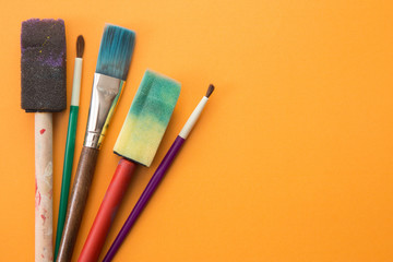 Children's Paint Brushes on a Orange Background