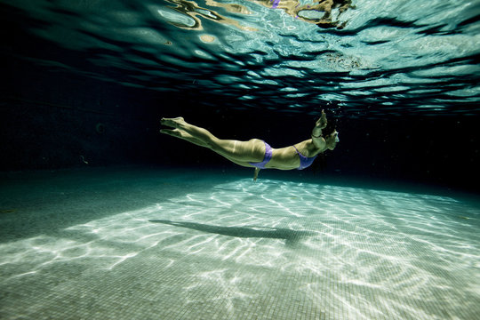 Underwater woman portrait with bikini in swimming pool