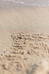 Message on the beach sand