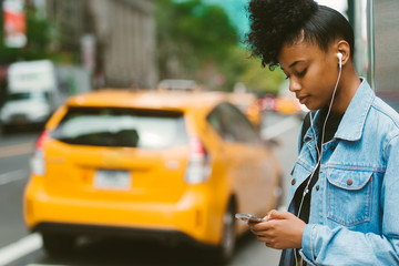 Woman checking her phone in the city