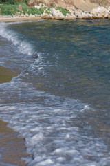 Close up of sea waves splashing on the beach