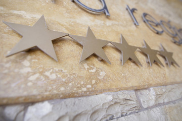 Five stars on a hotel logo at the entrance