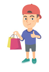 Happy caucasian boy holding shopping bags and giving thumb up. Little smiling boy with shopping bags. Vector sketch cartoon illustration isolated on white background.