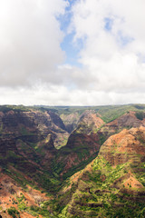 Aerial view on a sunny day over Waimea Canyon in Kauai, Hawaii - also known as The Grand Canyon of the Pacific