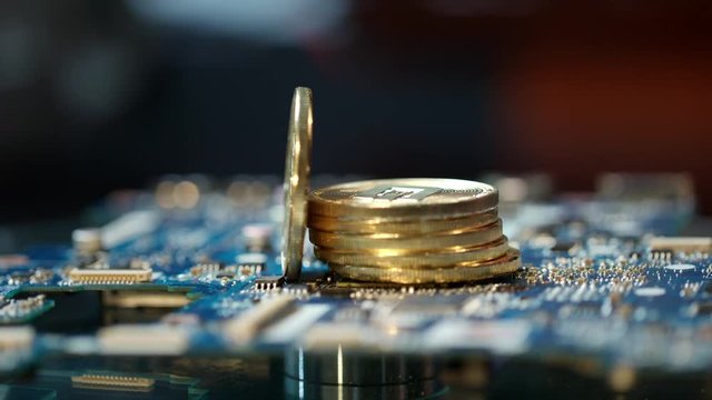 Bitcoin mining on gpu farm equipment. Close up of stack of gold bitcoins on circuit board. Modern blockchain technology. Virtual cryptocurrency mining business. Bitcoin mining concept
