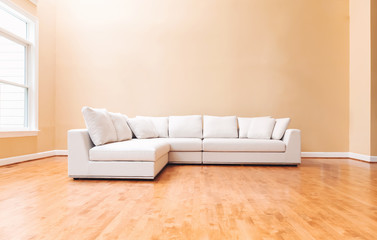 White sectional couch in a large luxury interior home