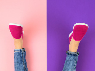 Legs of the girl in red sneakers and ripped jeans on the purple and pink floor. The view from the top.