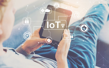 IoT Security theme with man using a tablet in a chair