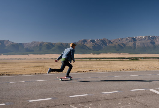 Man riding skateboard on rural rad