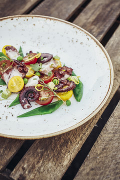 Octopus salad with seasonal tomatoes and green peas