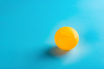 a dent pingpong ball on blue background