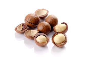 Macadamia nut with shell on wooden background
