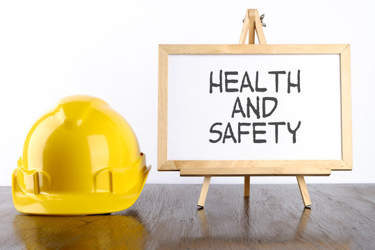 Safety helmet and white board with words Health and Safety,Health and Safety concept.