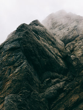 Closeup of Dark Limestone Peak Surrounded by Fog