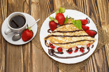 Crepes with Banana, Chocolate and strawberries with cup of coffee.