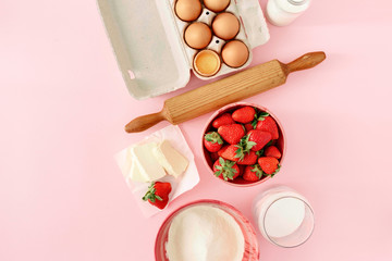 Fototapeta na wymiar Raw ingredients cooking strawberry pie pink background eggs flour milk sugar strawberry top view flat lay Bakery background Recipe strawberry pie