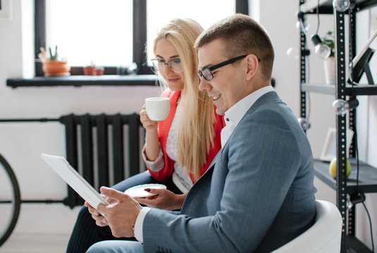 Cheerful Business People Reading Papers In Office