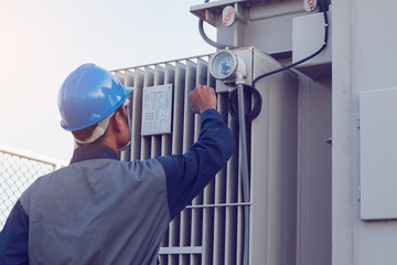 engineer or electrician working on checking and maintenance equipment at green energy solar power...