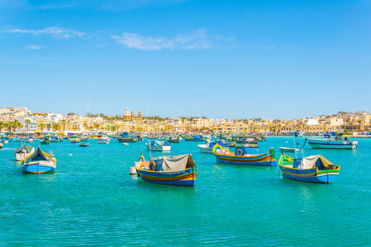 Colorful fishing boats moor in Marsaxlokk, Malta