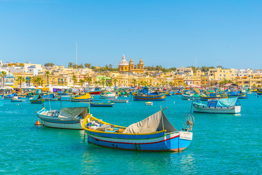 Colorful fishing boats moor in Marsaxlokk, Malta