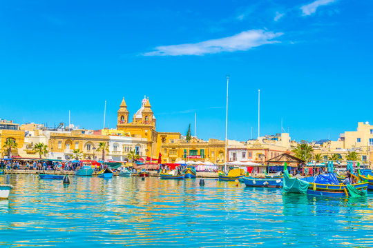Colorful fishing boats moor in Marsaxlokk, Malta