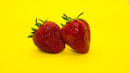 Strawberry fruit isolated yellow background