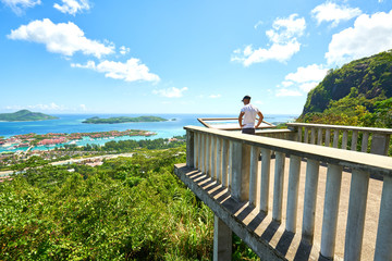 Tourist admires panoramic view of Victoria and Eden Islands, Mah