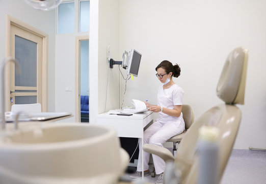 Dentist Doing Paperwork In Office