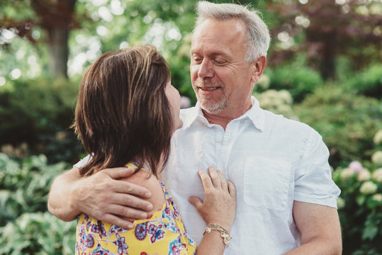 An attractive couple in their 50s poses for engagement photos