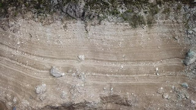 Stratifications of rocks and sand of the Lake Fregabolgia. An Alpine artificial lake. Italian Alps. Italy