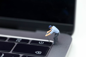 Miniature people : worker pull a  button of power laptop.