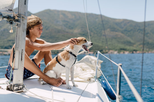 Teenager sailing with his dog